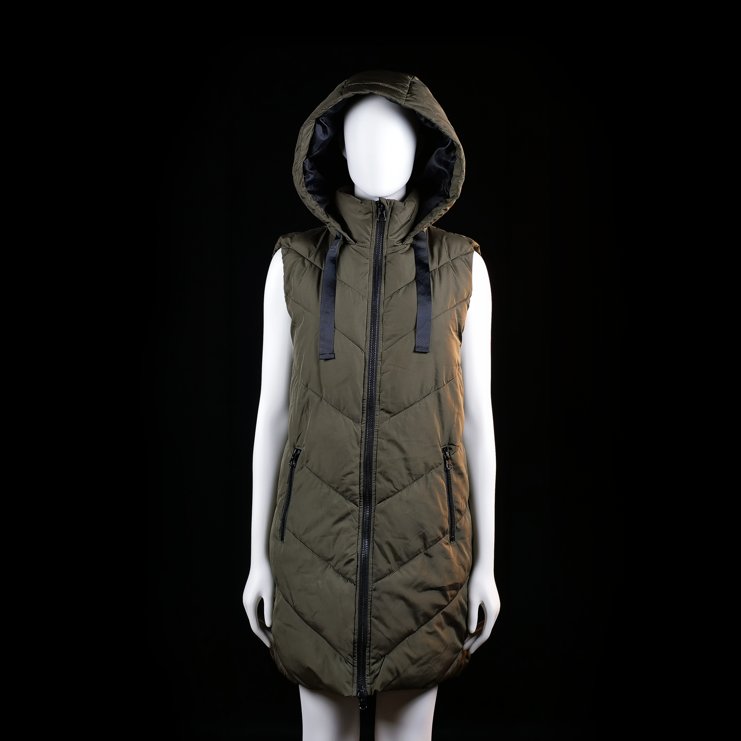 Jdy - Padded vest - Olive - Size S - Long padded sleeveless vest with chevron quilting, zip front closure, and a large attached hood with wide drawstrings. Features two zippered hand pockets on the front.