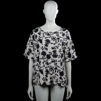 Hema - T-shirt - White & Black - Size L - White top with a black floral pattern and a round neckline. Features short sleeves with plain cuffs and a straight hem.