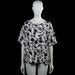 Hema - T-shirt - White & Black - Size L - White top with a black floral pattern and a round neckline. Features short sleeves with plain cuffs and a straight hem.