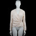 Kappahl - Blouse - Ivory - Size 38 - Ivory solid long-sleeve top with a V-neck wrap-style front and a circular ring detail at the waist. Straight hem and plain cuffs.