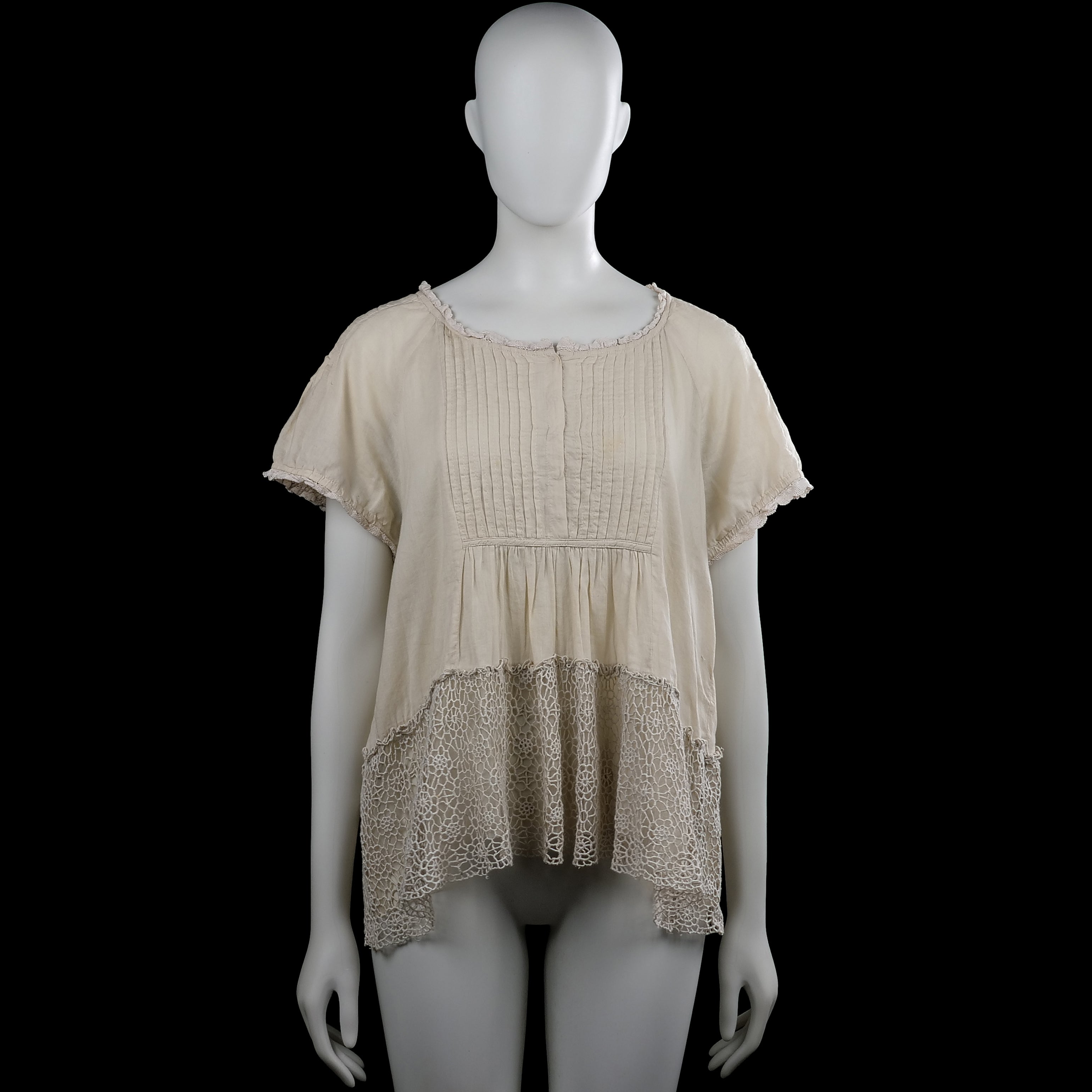 Raselbud - Tunic - Ivory - Size M - Ivory solid short-sleeve top with a scoop neckline and lace trim at the neckline and sleeve hems. Features pintuck pleats on the front and a high-low hem with a lace panel at the bottom.