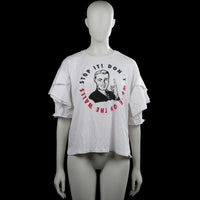 Zara trafaluc - T-shirt - White - Size M - White T-shirt with a round neck and short sleeves featuring layered ruffle details. Front has a graphic print with text, and the hem is straight.