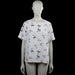 Primark - Blouse - White - Size 42 - White top with an all-over bird print and a round neckline. Features short sleeves with plain cuffs, a curved hem, and a back keyhole with a button closure.