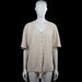 Made In Italy - Tunic - Beige - Size L - Beige solid top with a V-neck and short sleeves. Features a front button placket and a straight hem with a tie detail at the bottom.