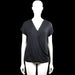 Ql - Blouse - Black - Size M - Black solid top with a V-neck wrap-style front and short sleeves. Straight hem with plain cuffs.