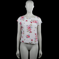S.oliwen - T-shirt - White & Pink - Size 36 - White top with a floral pattern in pink, blue, and green, featuring a wide boat neckline and short sleeves. Straight hem with a back cutout and crisscross strap detail.