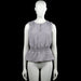 Kappahl - Tank top - Gray - Size M - Gray sleeveless solid top with a round neckline and a short center front slit. Features smocked shoulder panels, a smocked waist, and a flared peplum hem.