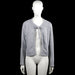 157 - Cardigan - Gray - Size M - Gray solid open-front cardigan with a round neckline and a tie closure at the chest. Long sleeves with plain cuffs and a straight hem.