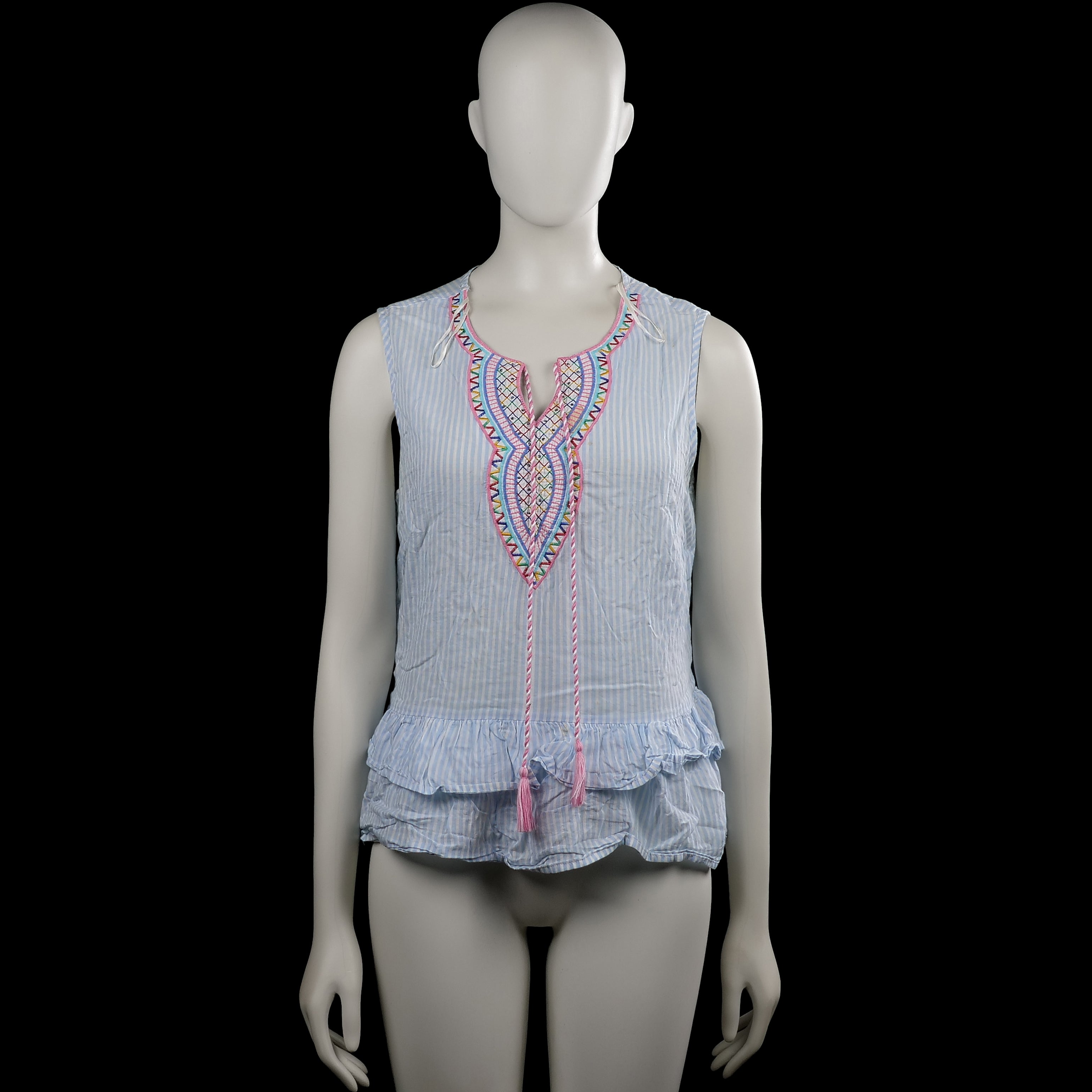 Falcon Heritage - Blouse - Light Blue & White - Size S - Light blue and white striped sleeveless top with a round neckline and a front slit with tie strings and tassels. Features multicolored embroidery around the neckline and a ruffled hem.