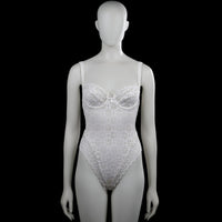 Chantelle - Bodysuit - White - Size XS - White sleeveless lace bodysuit with a scoop neckline and shoulder straps. Features floral lace patterning with a scalloped asymmetrical hem and a small bow at the front.
