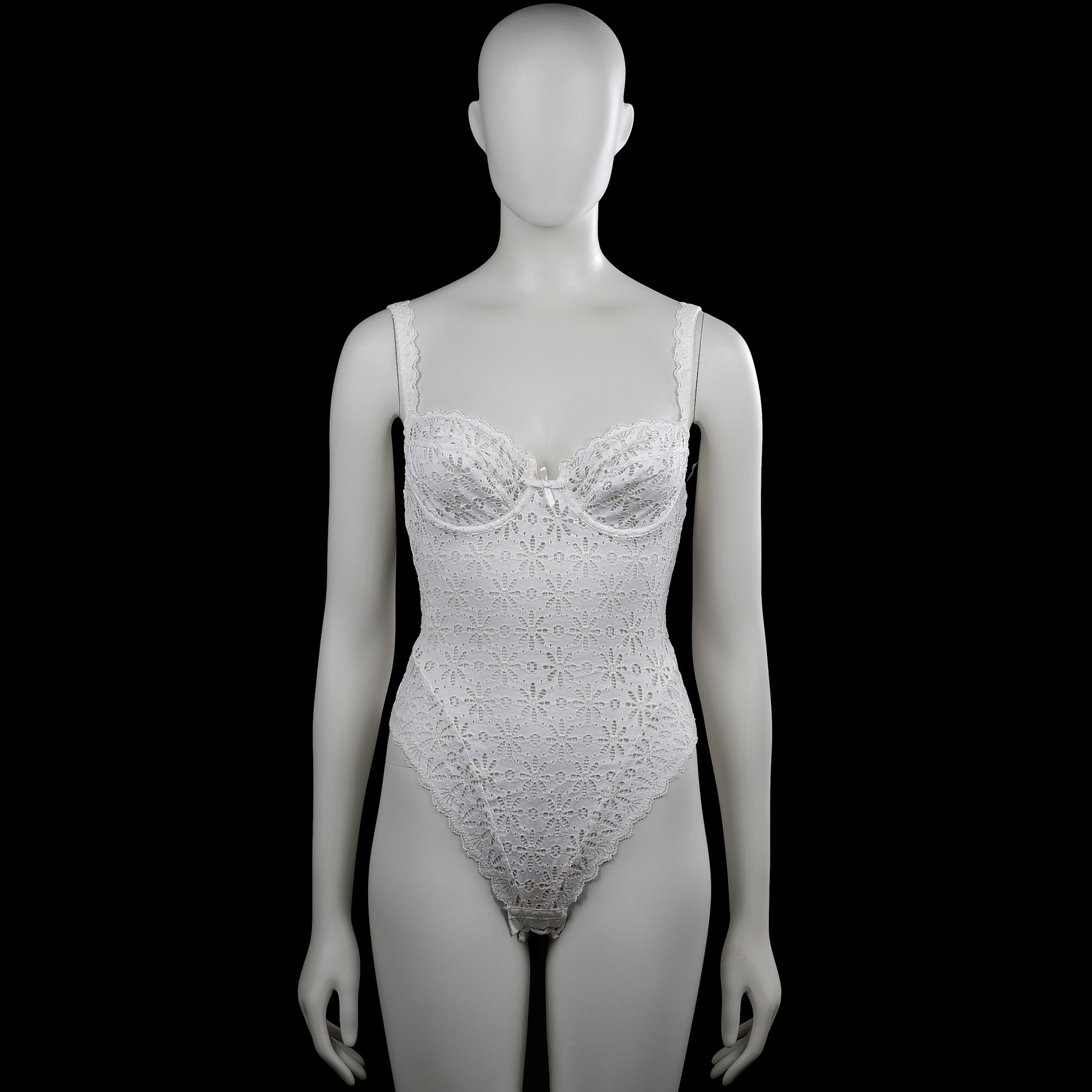 Chantelle - Bodysuit - White - Size XS - White sleeveless lace bodysuit with a scoop neckline and shoulder straps. Features floral lace patterning with a scalloped asymmetrical hem and a small bow at the front.