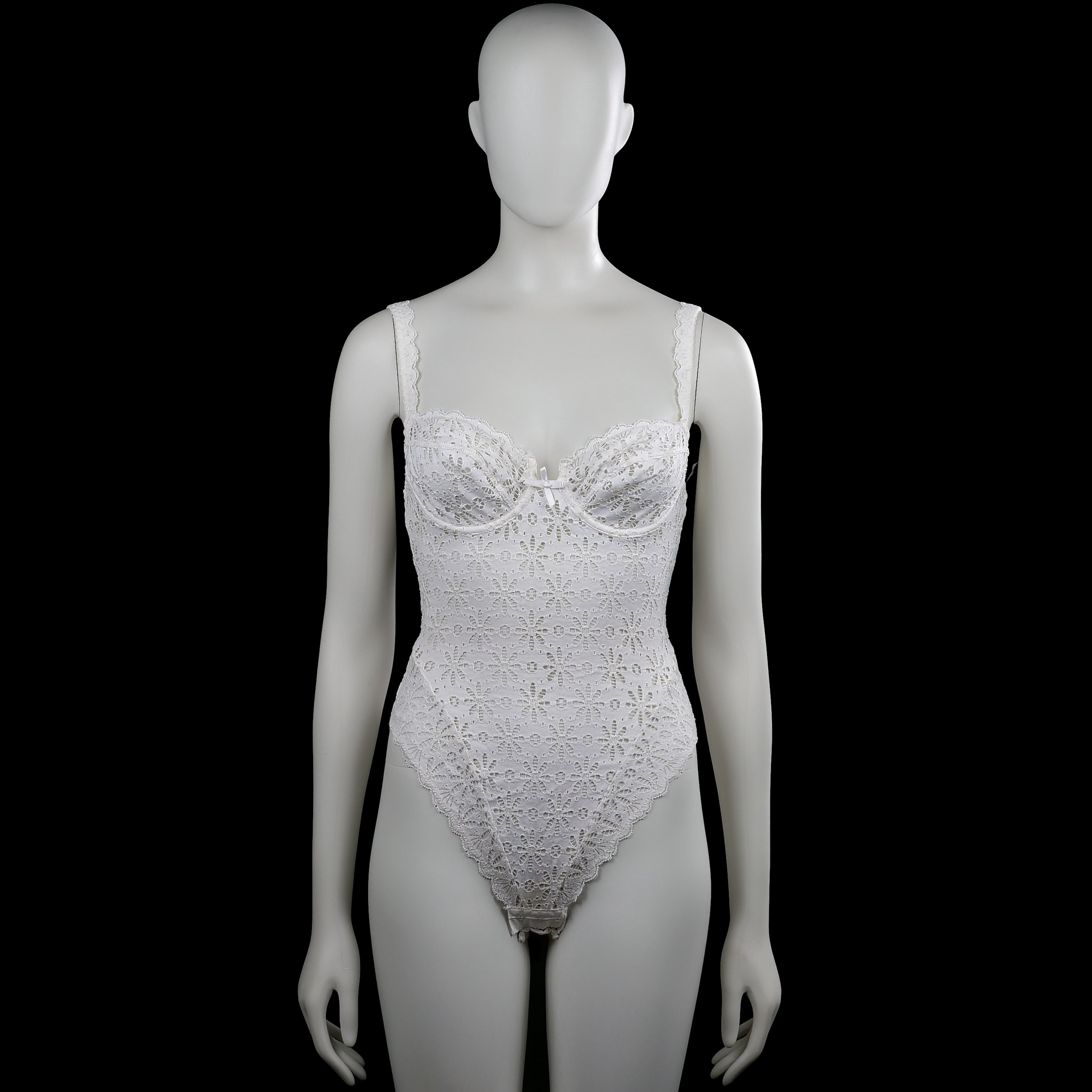 Chantelle - Bodysuit - White - Size XS - White sleeveless lace bodysuit with a scoop neckline and shoulder straps. Features floral lace patterning with a scalloped asymmetrical hem and a small bow at the front.