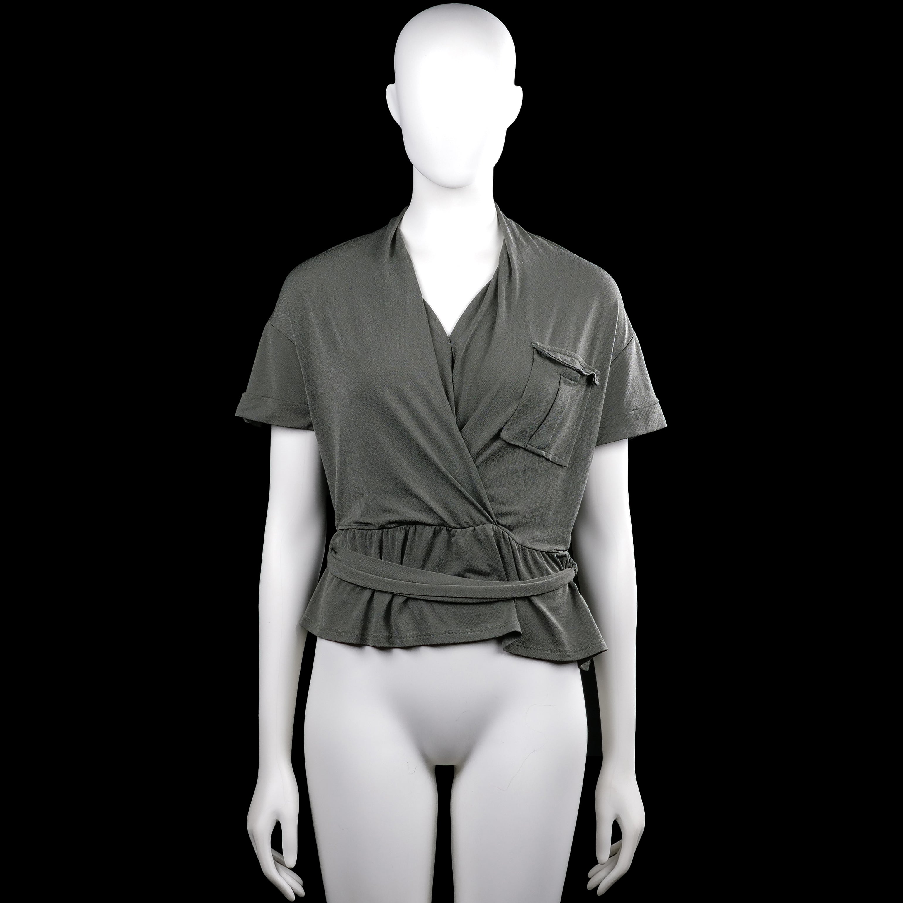 Even & do - Blouse - Olive - Size S - Olive solid top with a V-neck wrap front, short sleeves with button tabs, and a ruffle hem. Features a chest patch pocket and a self-tie belt at the waist.