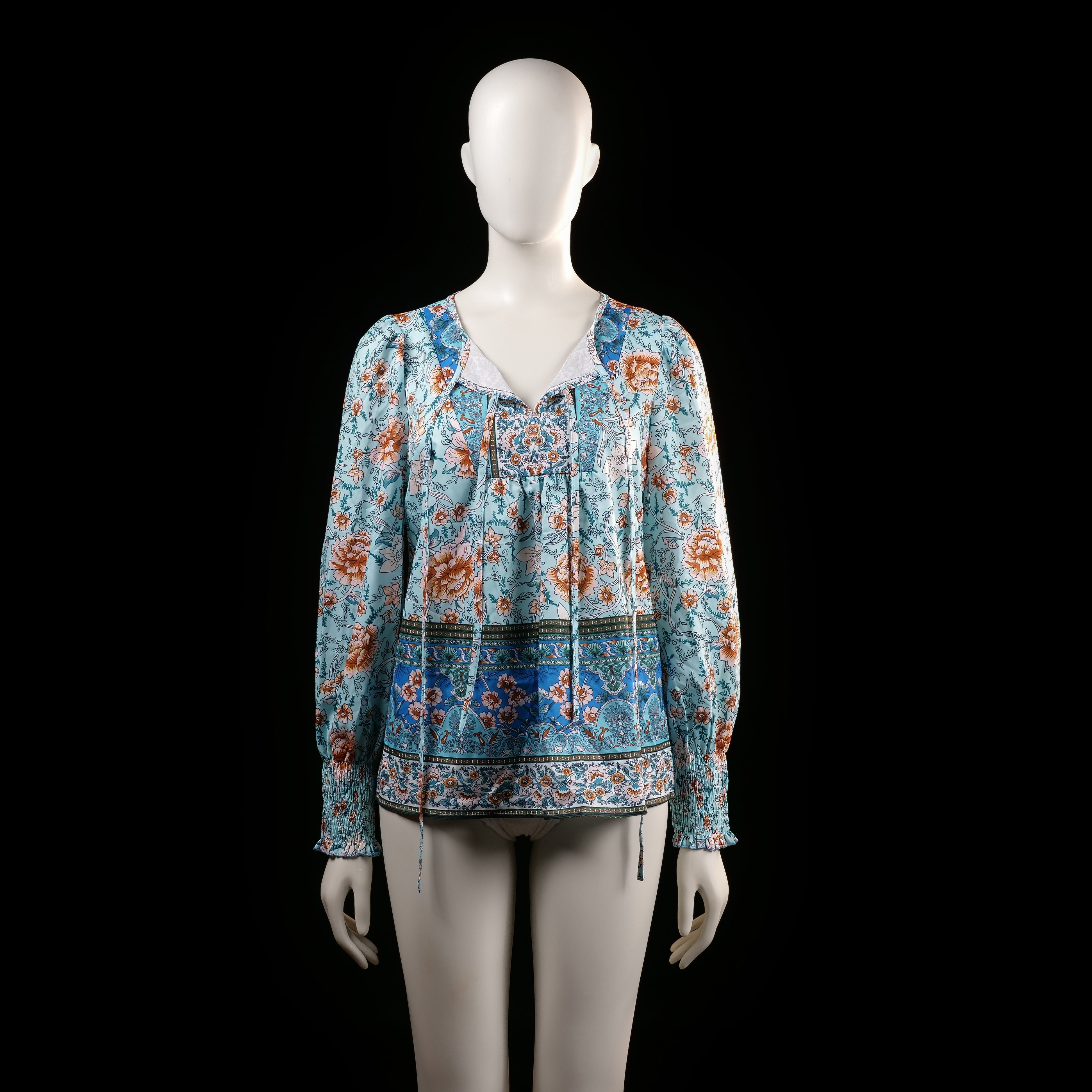 Blouse - Light Blue & Rust - Size S - Long-sleeve floral printed top with a gathered neckline and tassel ties. Features smocked cuffs and a border print along the hem and sleeves.