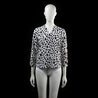 Savinni - Blouse - White & Black - Size S - Long-sleeve blouse with a V-neckline and an all-over irregular black spot print. Features sleeves with button tab detailing near the cuffs.