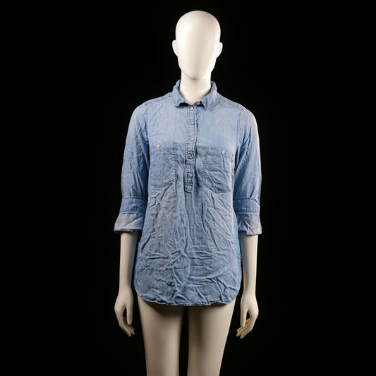 Mama - Tunic - Light Blue - Size S - Long tunic-style top with a partial button placket, collared neckline, and two chest flap pockets. Features roll-tab sleeves and a tie-back detail at the waist.