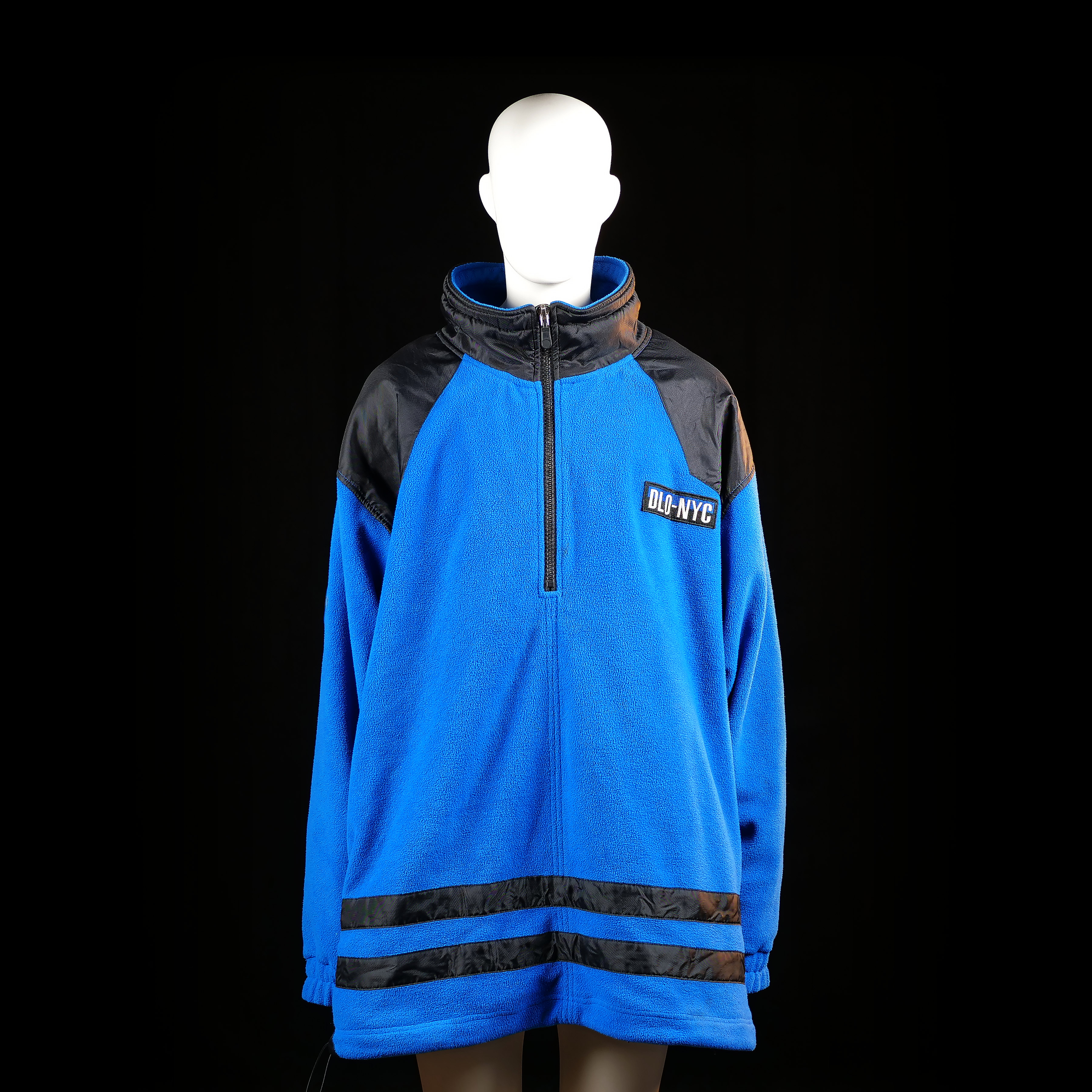 Dlo-nyc - Fleece jacket - Light Blue & Black - Size XXXXL - Oversized pullover fleece with half-zip front and high collar, featuring black synthetic panels across the shoulders and striping near the hem. “DLO-NYC” patch is visibly sewn on the left chest.