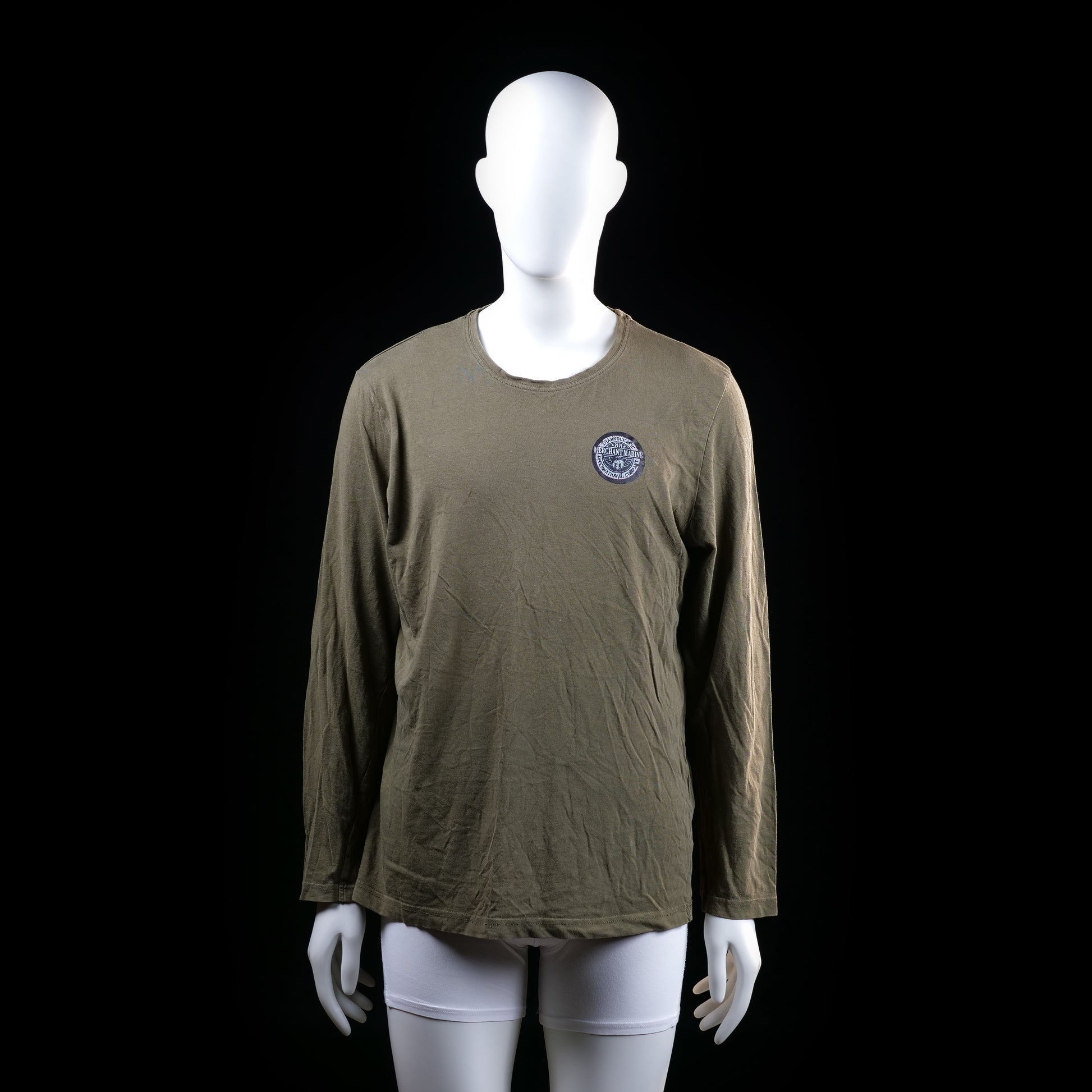 Merchant Marine - Long-sleeve top - Olive - Size M - Long-sleeve top with a round neckline and small round emblem graphic on the left chest. The hem and neckline have a raw, slightly distressed finish.