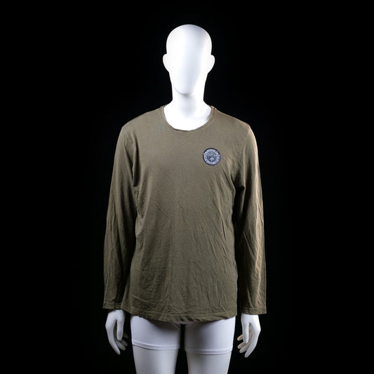 Merchant Marine - Long-sleeve top - Olive - Size M - Long-sleeve top with a round neckline and small round emblem graphic on the left chest. The hem and neckline have a raw, slightly distressed finish.
