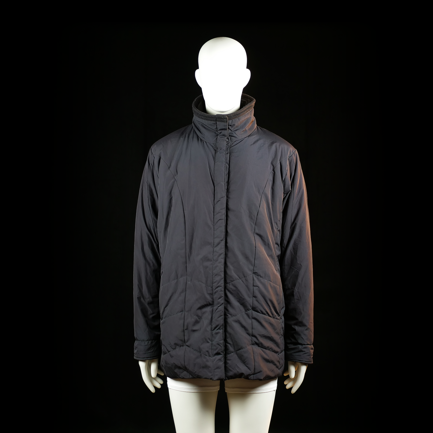 C&A Canda - Padded jacket - Black - Size 46 - Hip-length padded jacket with a high stand collar and concealed front zipper closure. Minimal stitching details are visible along the body and sleeves.