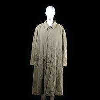 Cerruti 1881 - Trench coat - Taupe - Size 52 - Long coat with a slightly flared silhouette, button front closure, and a storm flap across the upper back. Features adjustable sleeve cuffs and angled front pockets.