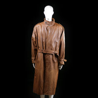 Eschel Krag - Trench coat - Brown - Size 48 - Long coat with a high stand collar, belted waist, and shoulder epaulets. Features wrist straps and a concealed front closure.