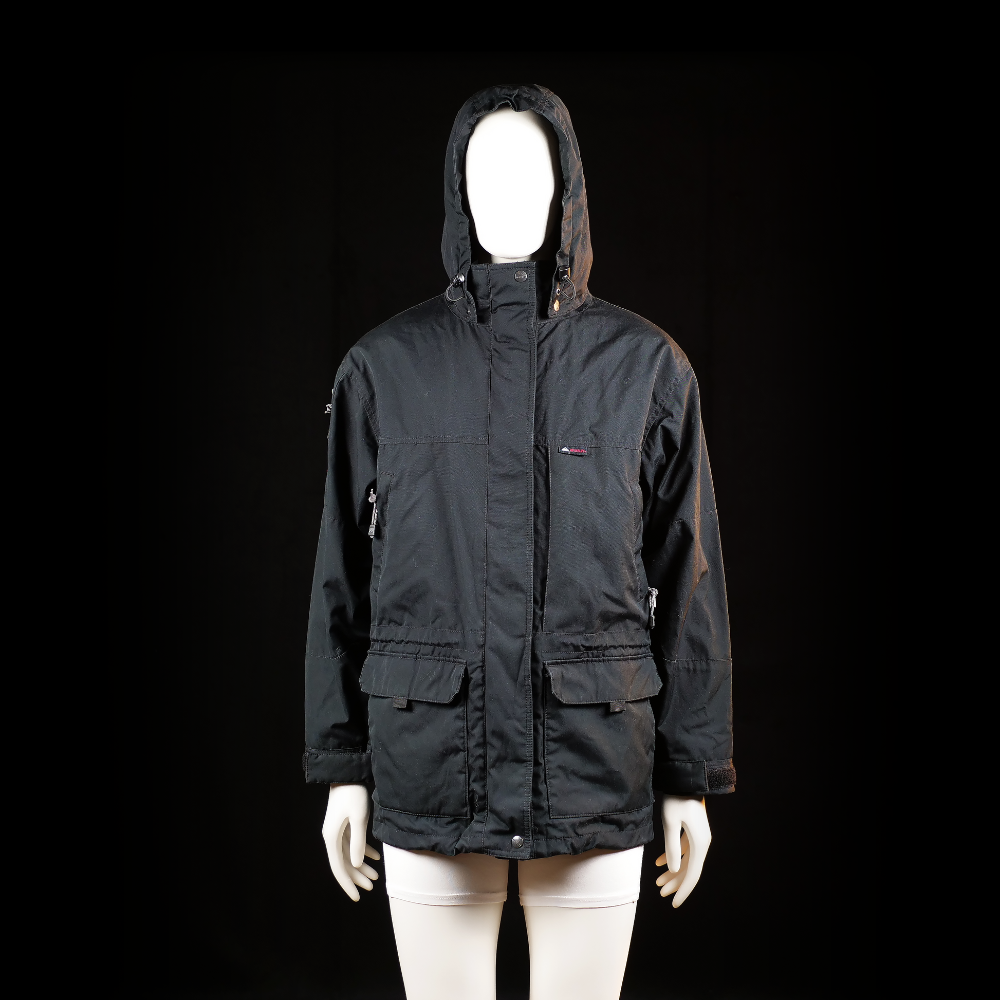 Mckinley - Parka - Black - Size 38 - Hooded jacket with a front zipper and snap closure, featuring adjustable drawcords at the hood and hem. Includes two front flap pockets and zippered side pockets.