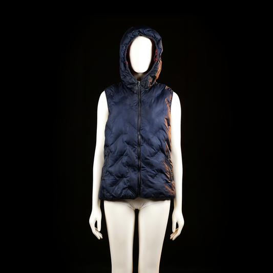 Nanica Kids - Padded vest - Navy - Size 158 - Sleeveless, quilted zip-up vest with a hood and side zipper pockets. The surface has a glossy finish with visible horizontal and diagonal stitching patterns.