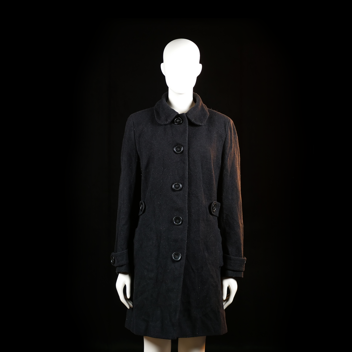 Yessica - Overcoat - Black - Size 42 - Long coat with a rounded collar, five front buttons, and decorative button-tab details at the cuffs and waist. Back has a smooth finish with symmetrical side waist tabs.
